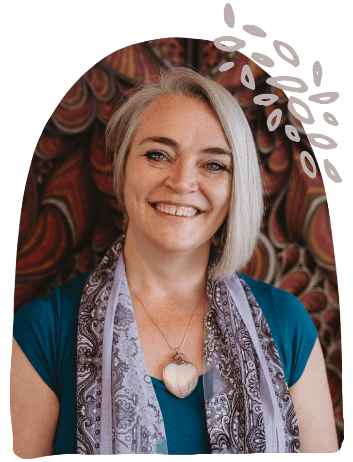 Cut out of Krystal Jakosky smiling in front of maroon woodwork art