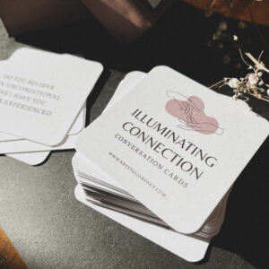 a deck of tan and purple cards on a black surface