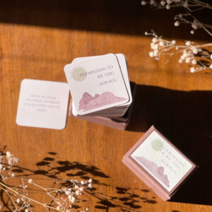 a deck of purple and tan cards on a wooden surface